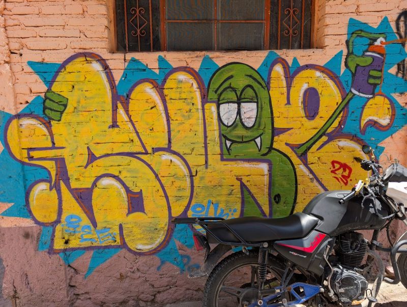 Fanged creature with spray can