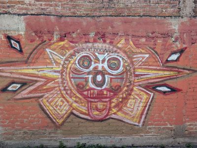 Sun face with greca rays