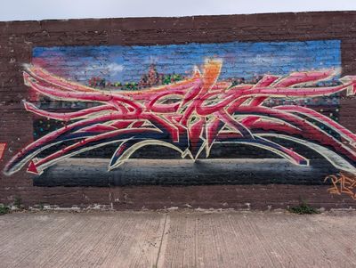 Grafiti rosa sobre una silueta urbana